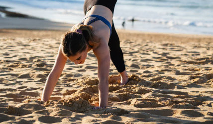A lady doing a yoga pose on the beach